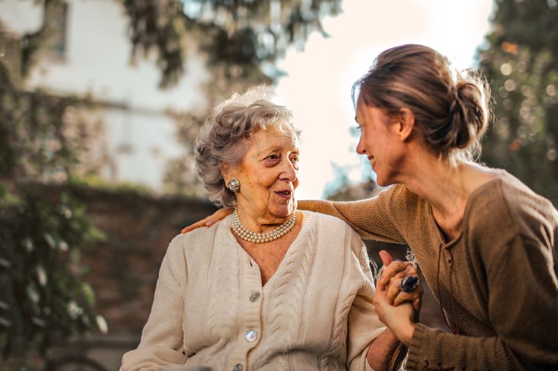 A caregiver and senior smiling together